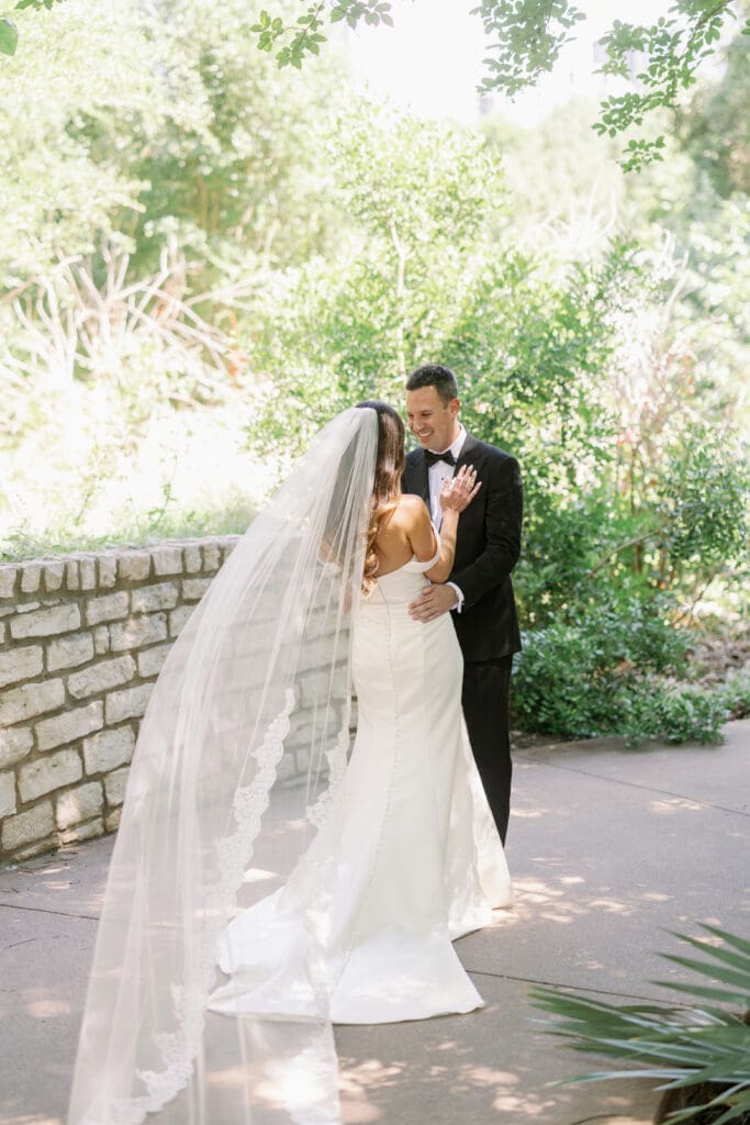 groom seeing bride for first look at four seasons austin wedding