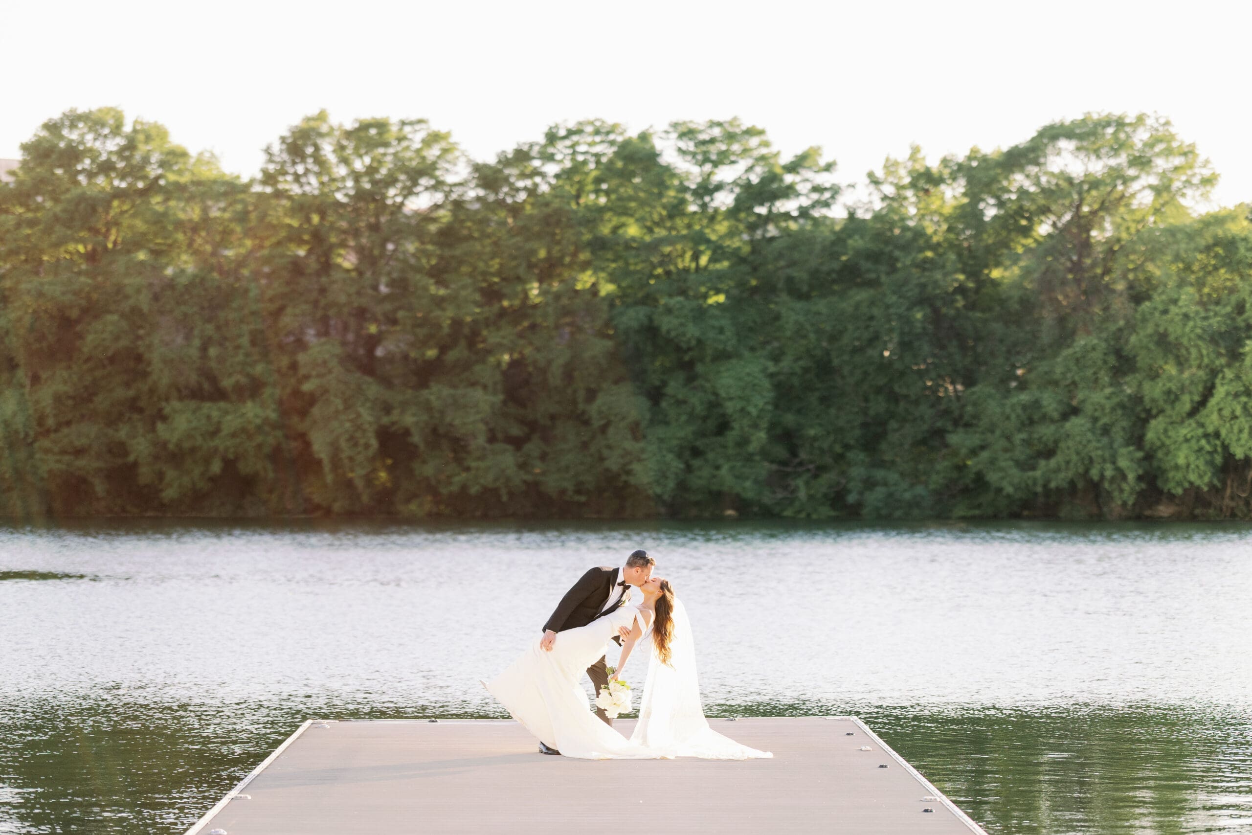 bride and groom kissing in a dip at four seasons austin wedding