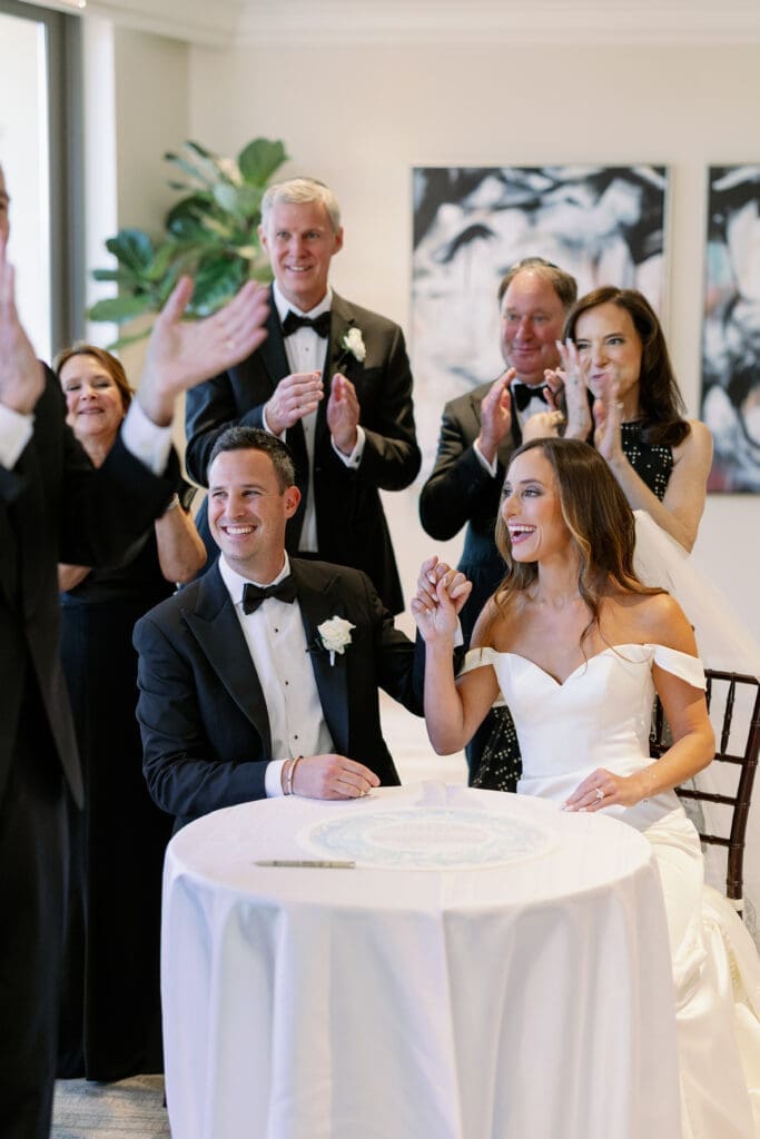 couple signing their ketubah at four seasons austin wedding