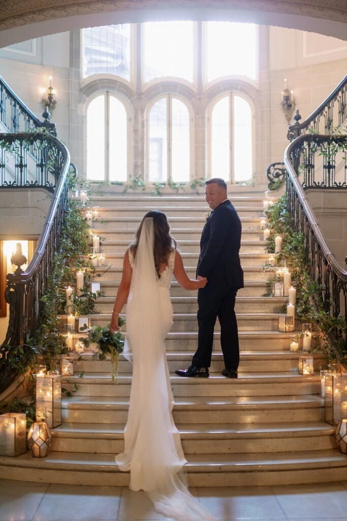 bride and groom walking up the stairs at The armour house lake forest