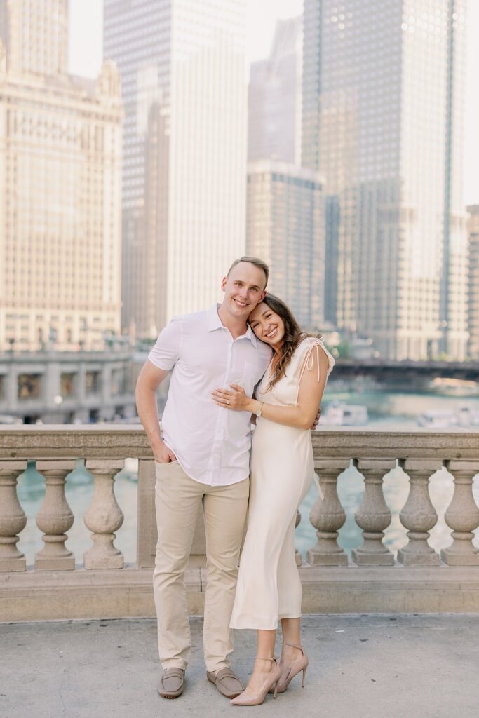 bride and groom posing at chicago riverwalk engagement photos