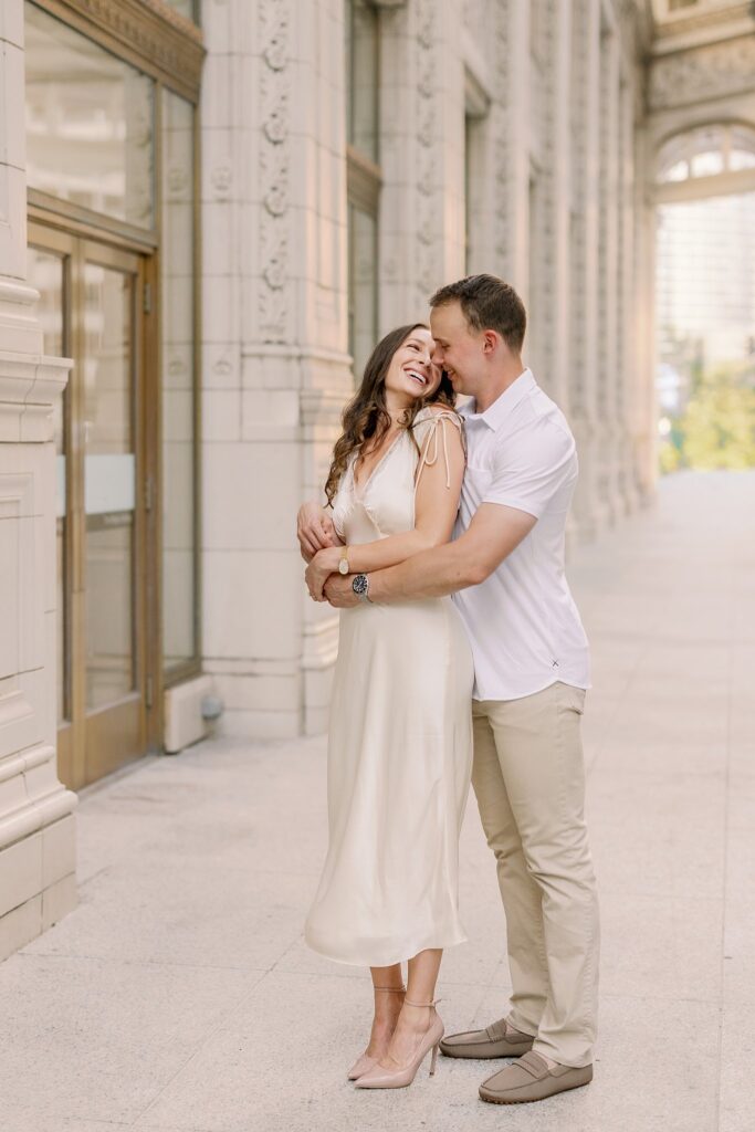 bride and groom posing at chicago riverwalk engagement photos