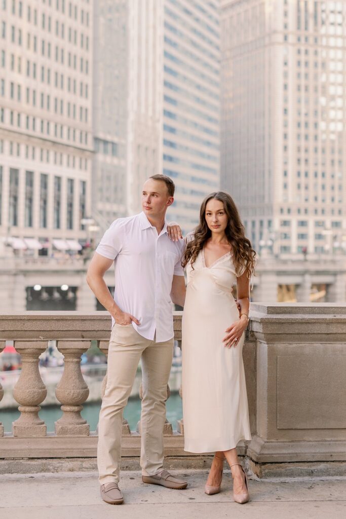 bride and groom posing at chicago riverwalk engagement photos