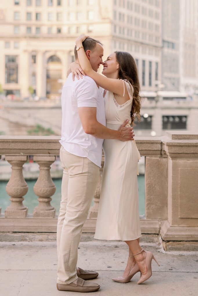 bride and groom posing at chicago riverwalk engagement photos
