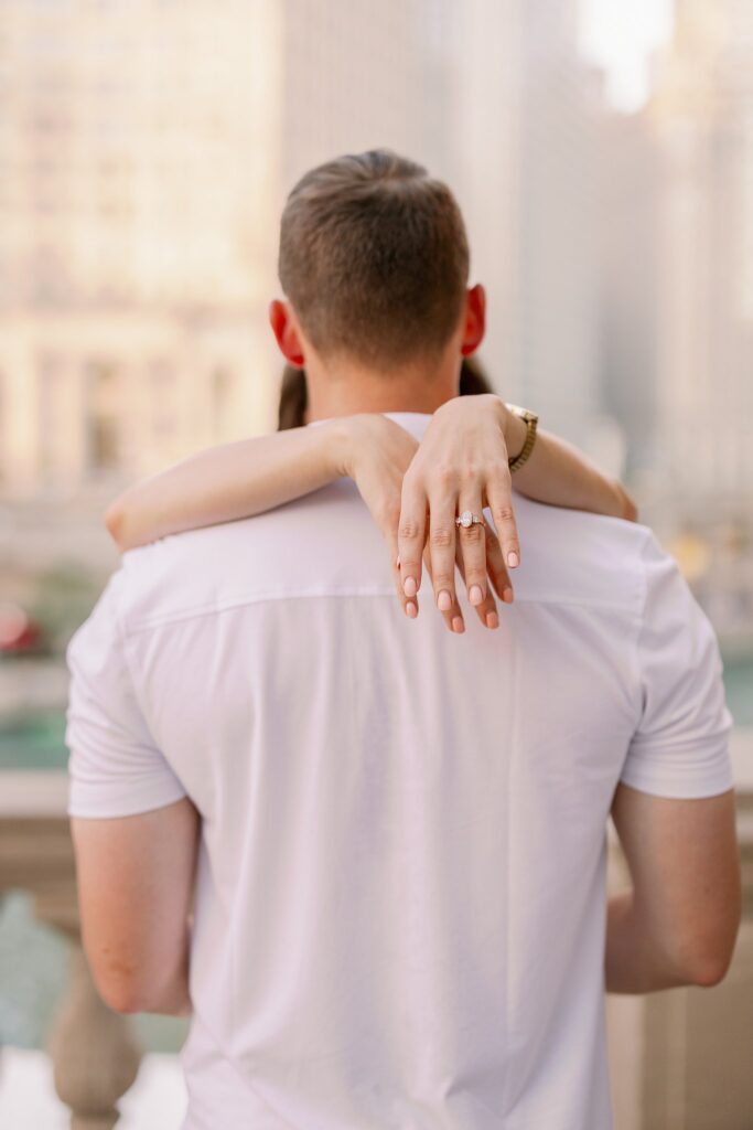 bride and groom posing at chicago riverwalk engagement photos