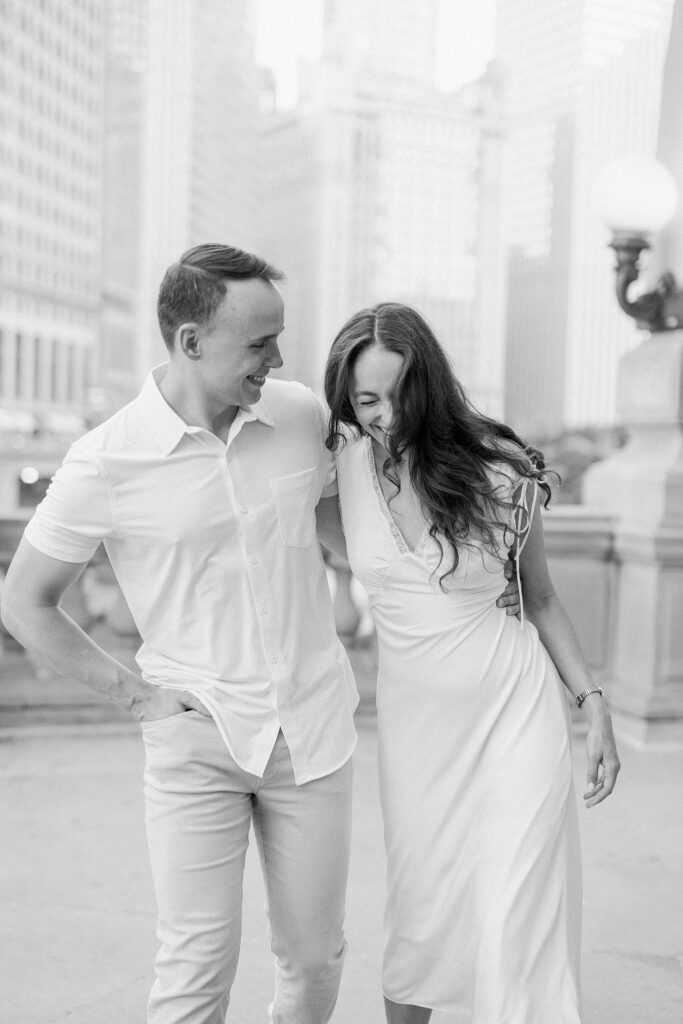 bride and groom posing at chicago riverwalk engagement photos