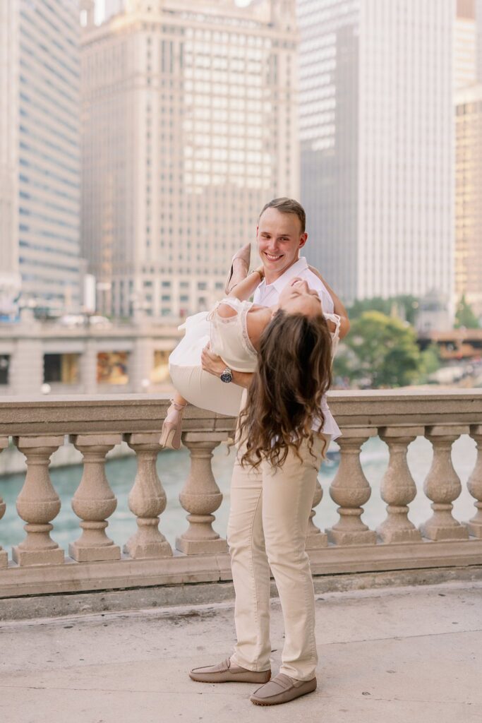 bride and groom posing at chicago riverwalk engagement photos