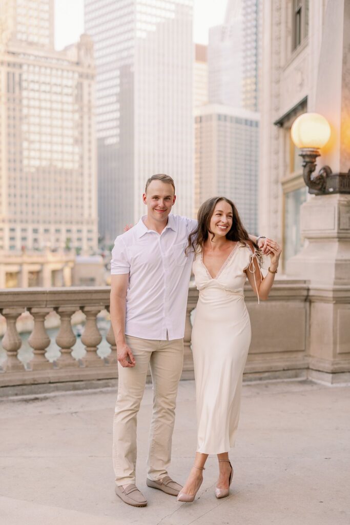 bride and groom posing at chicago riverwalk engagement photos