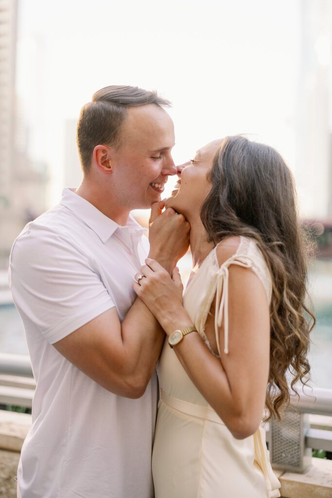 bride and groom posing at chicago riverwalk engagement photos