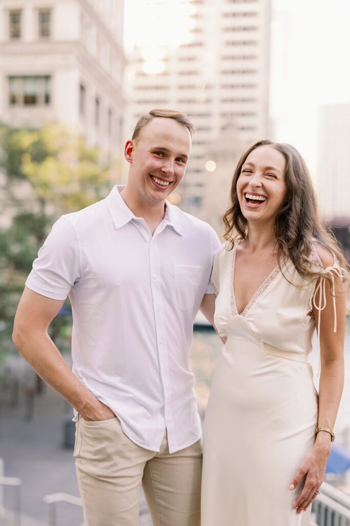 bride and groom posing at chicago riverwalk engagement photos