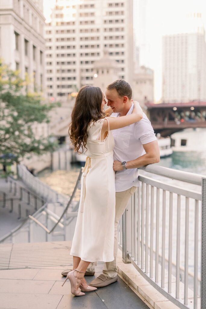 bride and groom posing at chicago riverwalk engagement photos