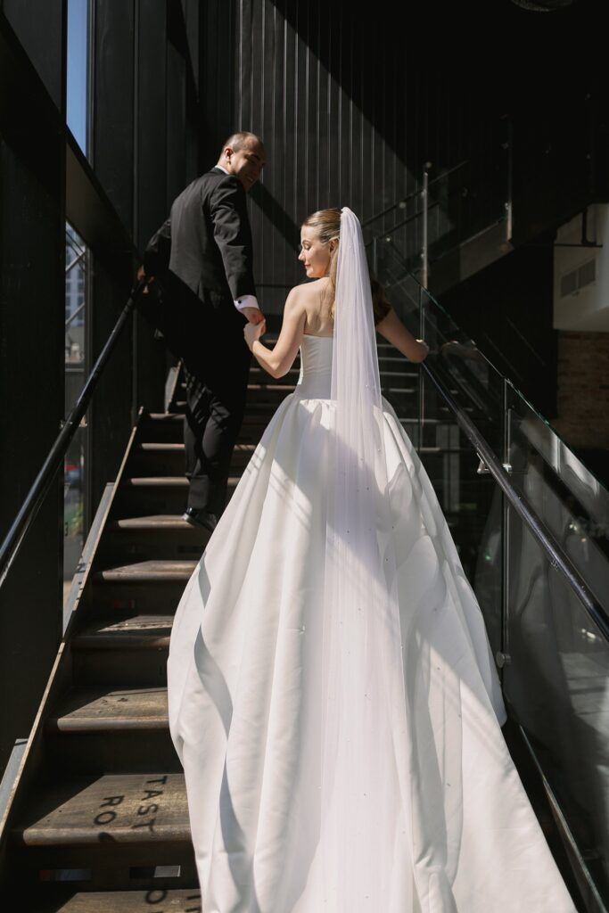 bride and groom pose on stairs for Chicago Winery Wedding