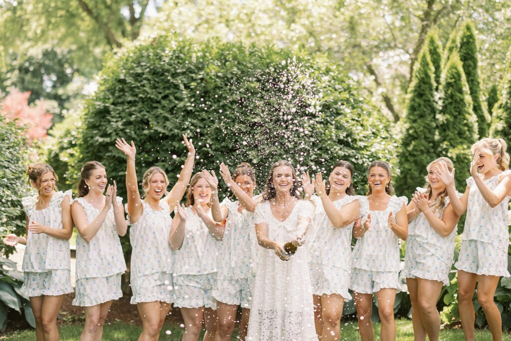 bride and bridesmaids popping champagne for stonebridge country club wedding