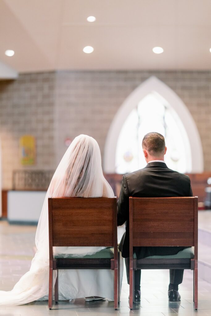 bride and groom sitting in church at stonebridge country club wedding