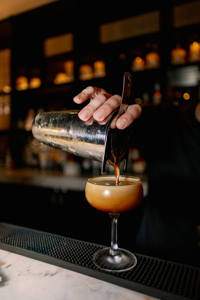 signature cocktail being poured at the dalcy wedding
