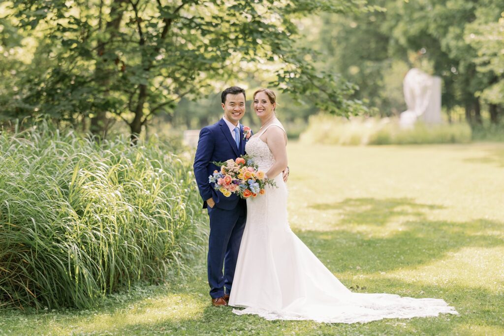 bride and groom pose for the grove redfield estate wedding