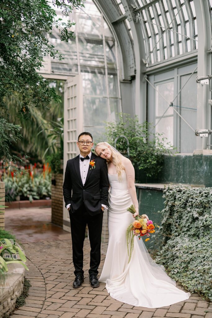 bride and groom pose after their Garfield Park Conservatory Wedding