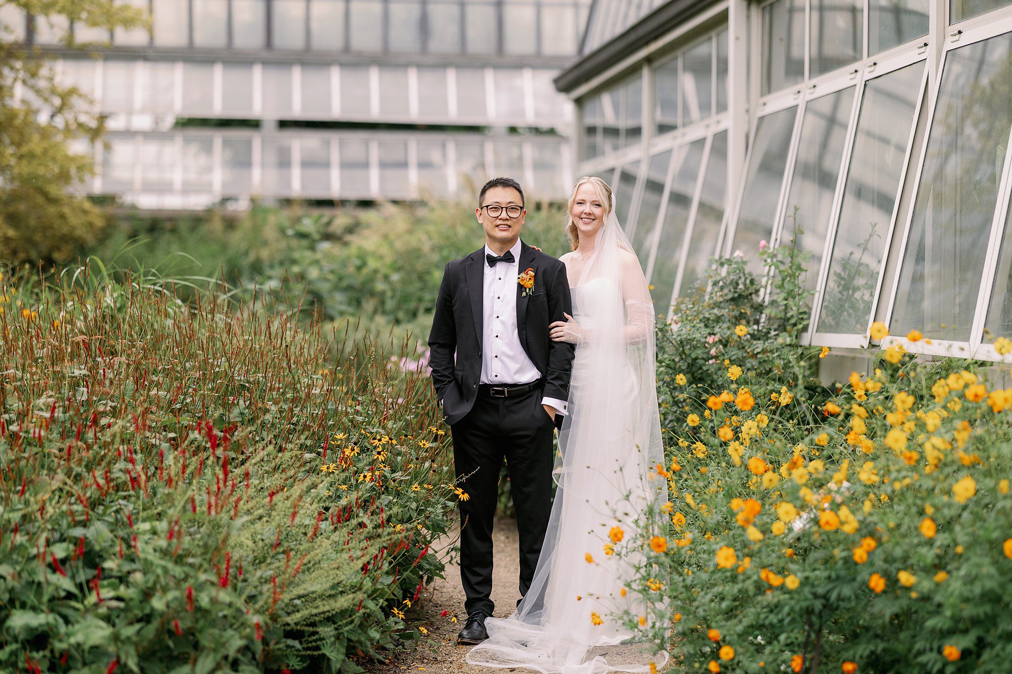 bride and groom pose outside at Garfield Park Conservatory Wedding
