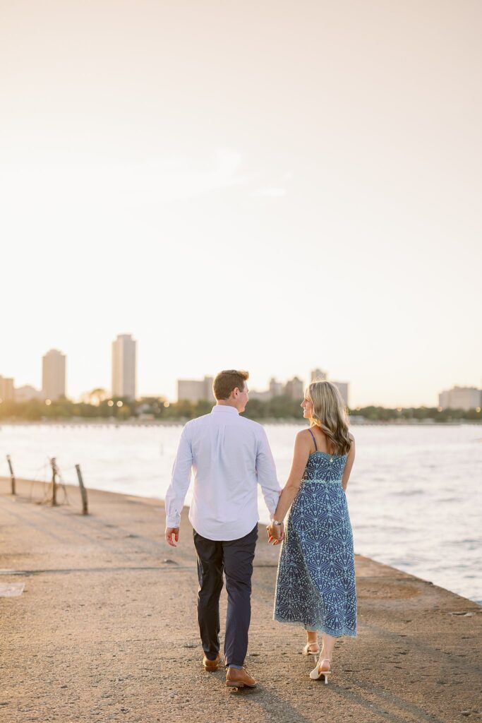 engaged couple walks the beach at North Avenue Beach in Chicago