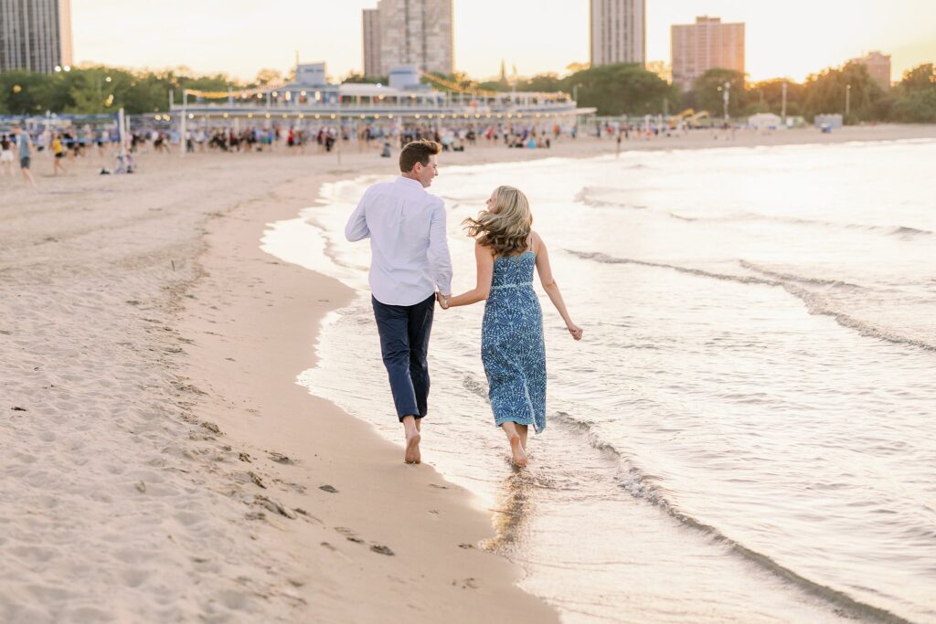 engaged couple walks the beach at North Avenue Beach in Chicago