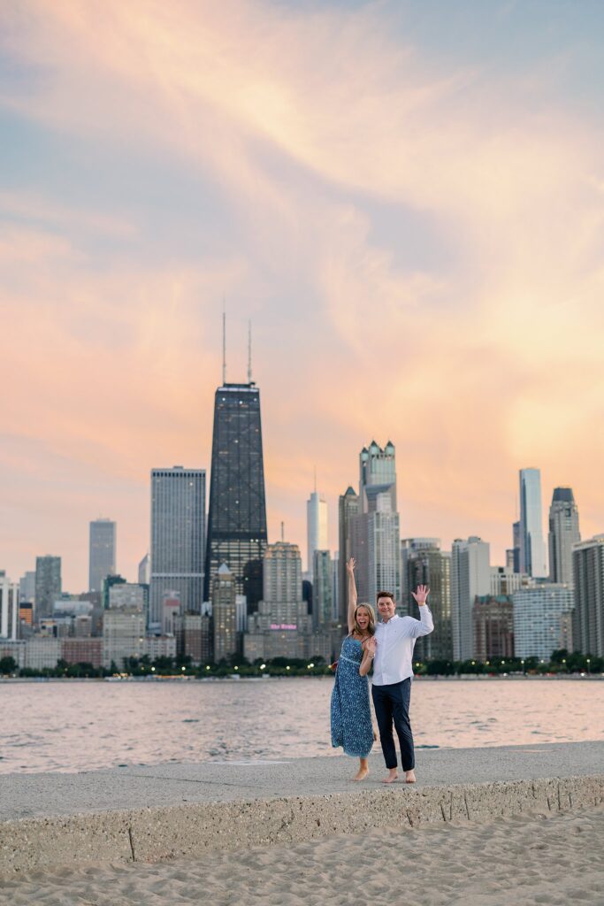 engaged couple walks the beach at North Avenue Beach in Chicago