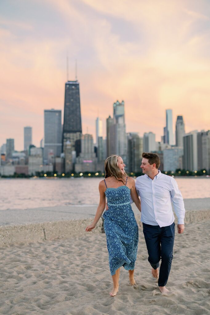 engaged couple walks the beach at North Avenue Beach in Chicago