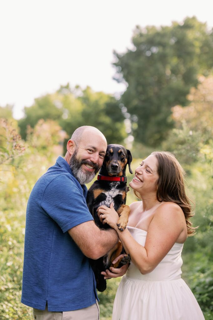 Engaged Couple poses at Winnemac Park in Chicago with dog